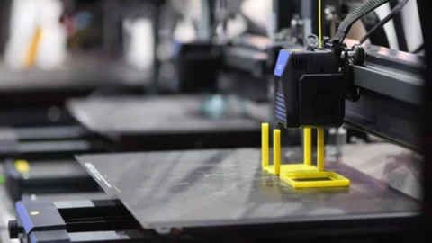 Close-up of 3D printer in motion, constructing yellow part 스톡 동영상 345378545
