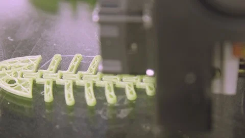 Close Up of 3D printer while printing fish form. Plastic skeleton of fish lies Stock Footage 95426857
