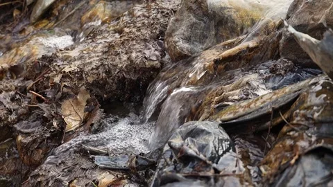 A close-up of a 4-fold slow-motion video of a clear stream of water flowing.. Stock Footage 315217596