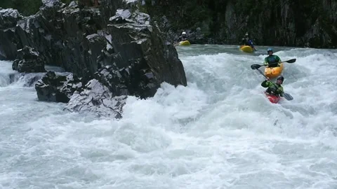 Close up 4 people kayaking  on emerald whitewater river, over rapids Stock Footage 139041887
