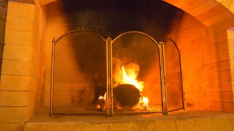 Close-up, 4k, fire and smoke in the fireplace through a protective mesh for the Stock Footage 89813155