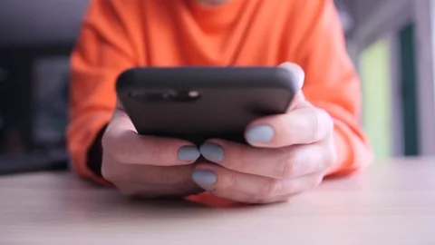 Close up 4k footage of using smartphone. Young woman holding her mobile Stock Footage 124008995