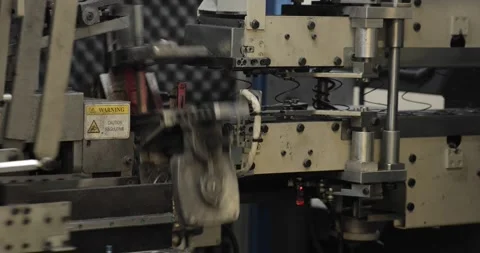 Close-up 4K shot of a functioning spring manufacturing machine in an Eastern Video stock 294681002