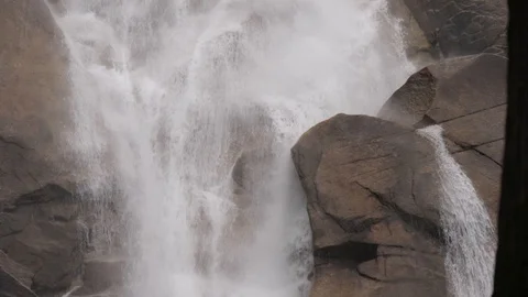 Close up 4k Shot of Waterfall Cascading Over Rocks Creating Slight Mist Stock Footage 93813323