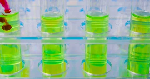 Close-up 4k video - drops of infected blood fall into a test tube with a Stock Footage 170823767