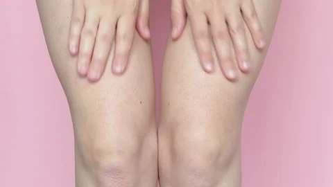 Close up 4k video,woman is massaging with both hands her legs and knees Stock-Footage 197644222