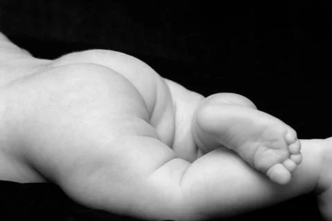 Close up of 5 weeks old child butt and legs monochrome Stock Photos