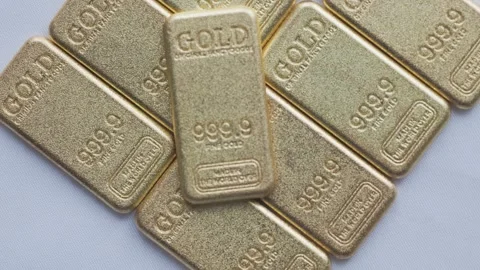 Close-up of 50 Gram Pure Gold Bullion Bars on a Reflective Surface Stock Footage 327799906