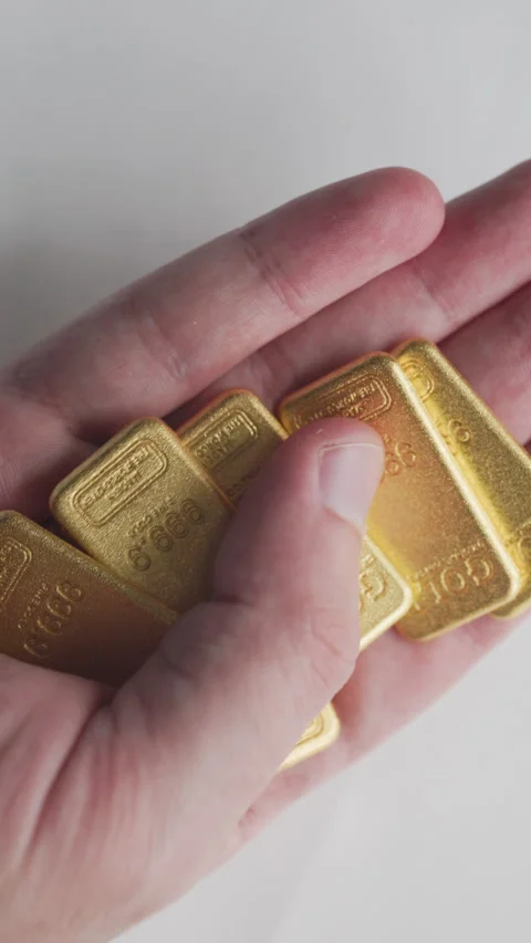 Close-up of 50 Gram Pure Gold Bullion Bars on a Reflective Surface Stock Footage 327822603