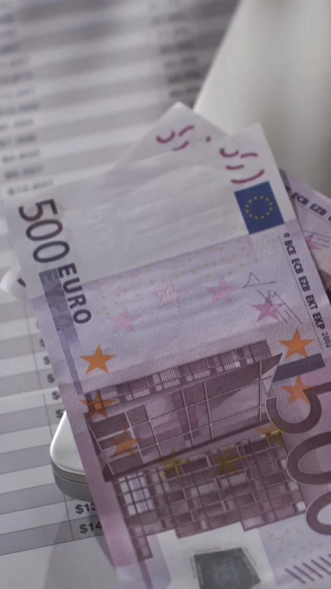 Close-up of a 500 Euro bill moving over financial documents in slow motion Stock Footage 337845145