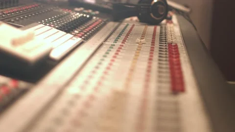 Close up of a 64 channel analog mixing table with red faders and knobs and Stock Footage 142467189