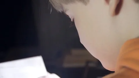 Close up of 7 year old caucasian white boy reading a children's book, holding bo Stock Footage 87246558