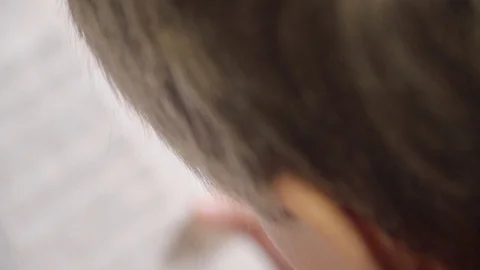 Close up of 7 year old caucasian white boy reading a children's book, holding bo Stock Footage 87246728