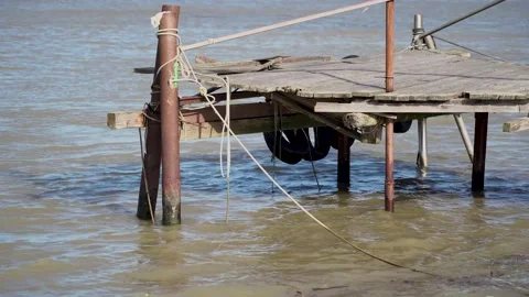 Close up of an abadonated old jetty on the sea, dirty water Stock Footage 148416279