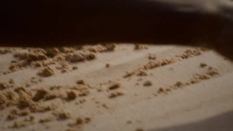 Close-up of an Aboriginal Australian hand tracing patterns in soft sand Stock Footage 332545494