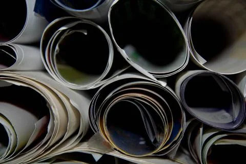Close-up from above view of bunch of white printing paper rolls and colored f Stock Photos