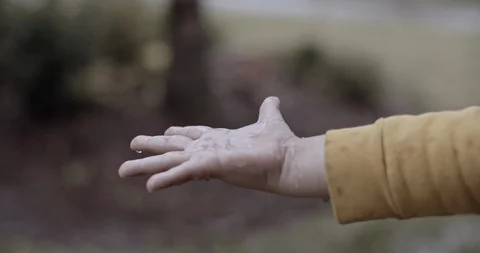 Close up of aboy hand under the rain Stock Footage 128854790