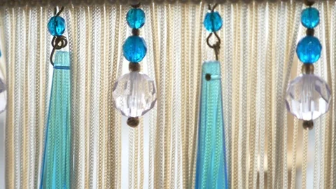 Close-up, abstract background. blue and beige tassels and beads on the floor Stock-Footage 118992629