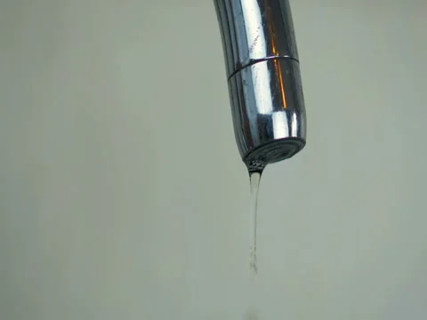 Close-up abstract a droplets of water drip from the tap in the kitchen at home. Video stock 82785365