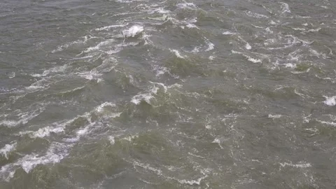 Close up abstract framing of turbulent river waves crashing violently with white Video stock 342477375