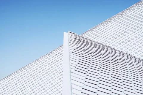 Close up of abstract geometric structure white wall and roof top against blue Stock Photos
