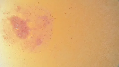 Close-Up of Abstract Golden Surface with Red Speckles and Glimmering Texture Stock Footage 314833592