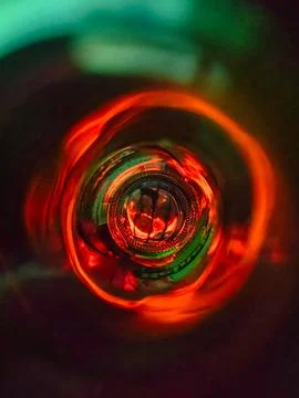 Close-up abstract image taken from inside a glass bottle, showcasing vivid .. Foto stock