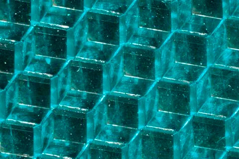 A close up abstract macro photo of a plastic reflector lit with an aqua flash Stock Photos