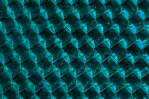 A close up abstract macro photo of a plastic reflector lit with an aqua flash Stock Photos