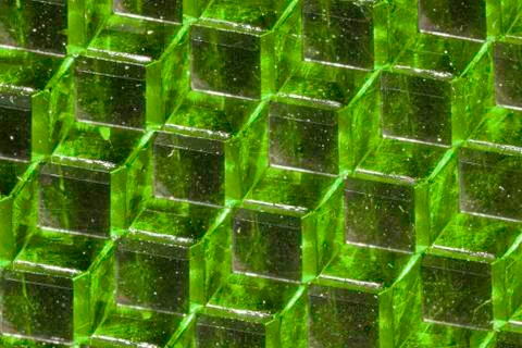 A close up abstract macro photo of a plastic reflector lit with a green flash Stock Photos