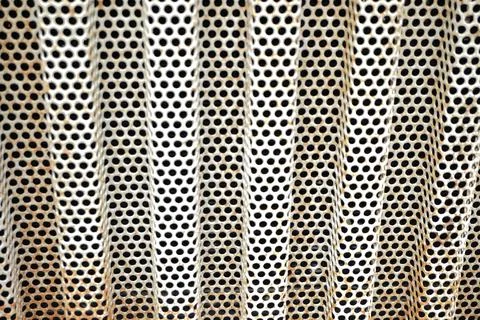 Close-up abstract texture of a perforated metal sheet Stock Photos