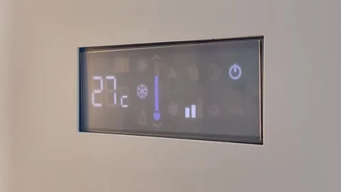Close-up of AC digital display showing temperature adjustment to 22°C Stock Footage 311966137
