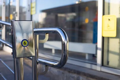 Close-up of accessibility button with wheelchair symbol on stainless steel .. Stock Photos