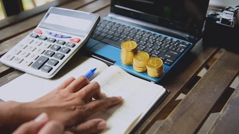 Close up accountant audit using calculater to calculate financials graph anal Stock Footage 111352755