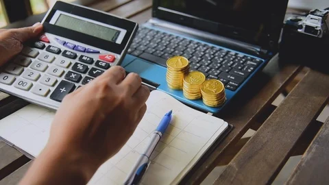 Close up accountant audit using calculator to calculate financials graph anal Stock Footage 111821785