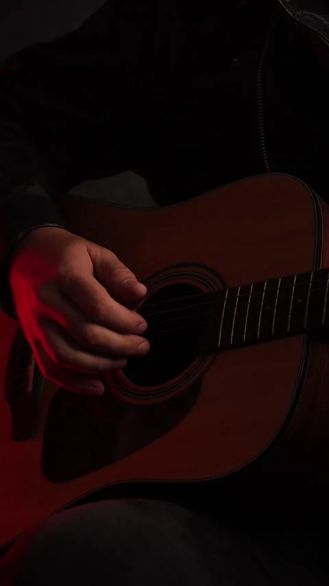 Close up of acoustic guitar strings and musician hand in warm lighting, captu Stock Footage 342237895