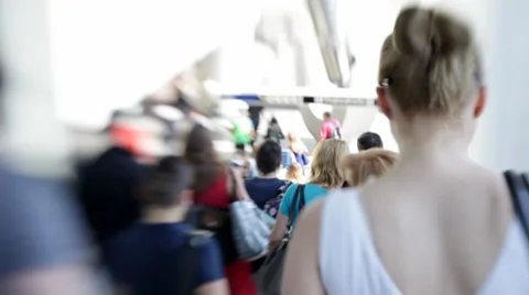 Close to action among a crowd of busy people walking in city surounding Stock Footage 39708034