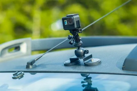 Close-up action camera on a flexible tripod on the roof of an SUV, travel c.. Stock Photos