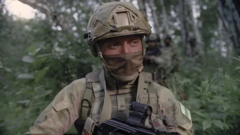 Close-up action shot, an armed special forces soldier with a rifle in his hands Stock Footage 327352590