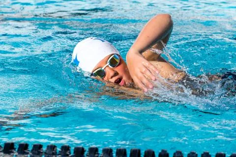 Close up action shot of teen swimmer. Stock Photos