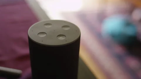 Close up on an activated virtual assistant smart home device speaker Stock Footage