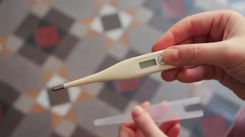 Close-up of activating a medical device for temperature measurement. Stock Footage 336385122