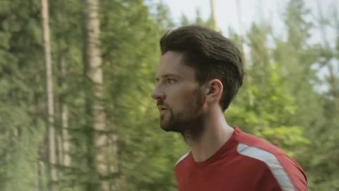 Close-up of active and determined man running in nature Video stock 74552247