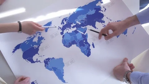 Close-up of active employees analyzing the world map Video stock 73864004