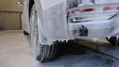 Close-up of active foam on a dirty car. Self-service car wash. Stock Footage 272889945