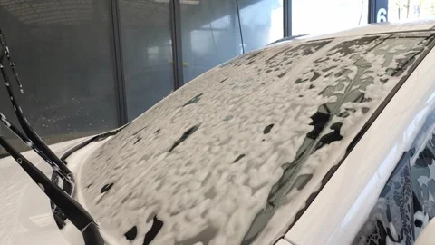 Close-up of the active foam on the windshield of the car. Self-service car wash. Stock Footage 273970118