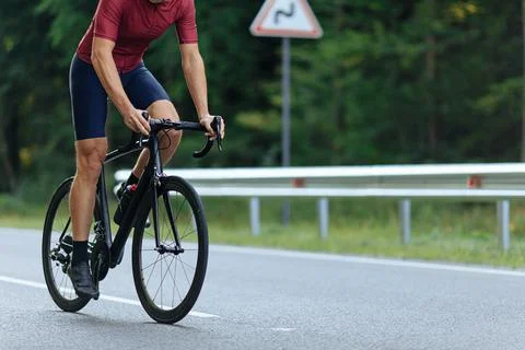 Close up of active man biking on paved road Stock Photos
