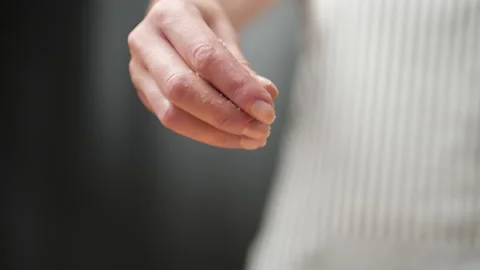Close-up adding cheese on top of the pizza in slow-motion in 4K. Stock Footage 137484631