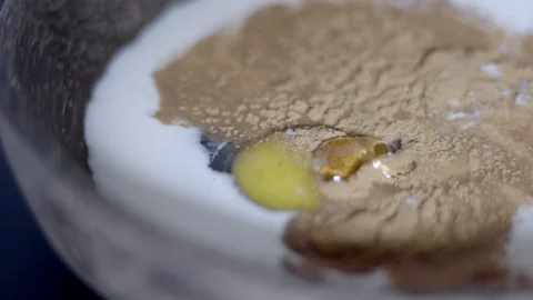 Close up adding cinnamon extract to mixture of milk and eggs.  Stock Footage