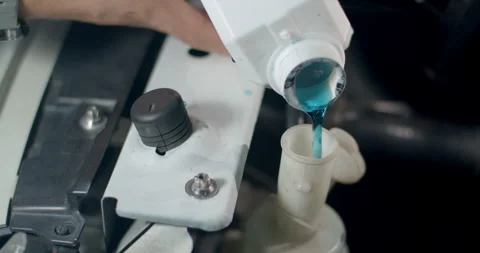 Close up adding Coolant to Car radiators or Pouring antifreeze to car radiator. Stock Footage 310912020